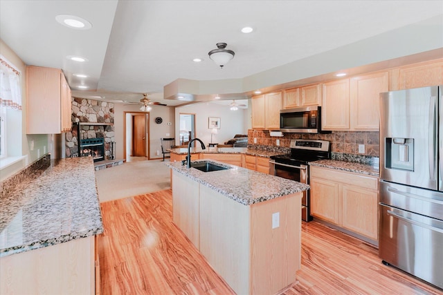 2098 Fisher Ct, Howell, MI 48855 - kitchen featuring appliances with stainless steel finishes, light brown cabinets, a ceiling fan, open floor plan, and recessed lighting