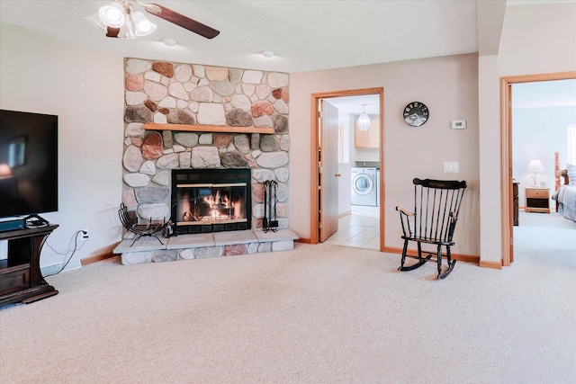 2098 Fisher Ct, Howell, MI 48855 - living area featuring washer / clothes dryer, carpet flooring, a fireplace, and a ceiling fan