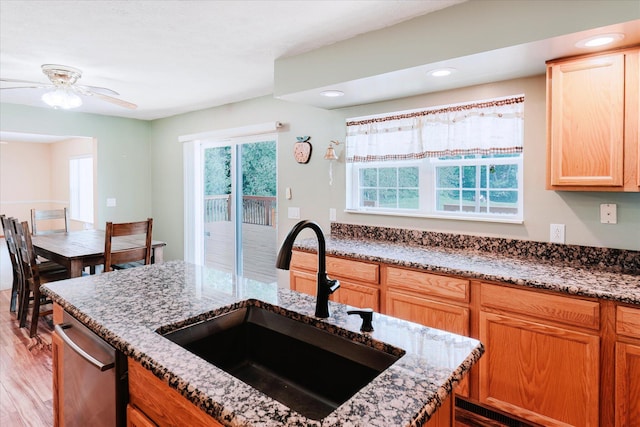 2098 Fisher Ct, Howell, MI 48855 - kitchen with light stone countertops, light wood-style floors, stainless steel dishwasher, recessed lighting, and a ceiling fan