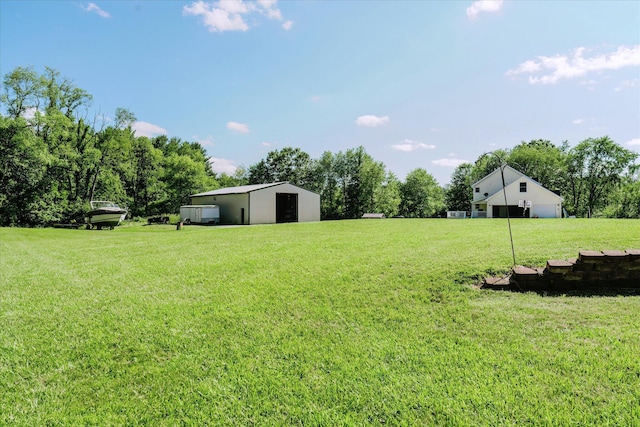 2098 Fisher Ct, Howell, MI 48855 - view of green lawn featuring an outbuilding and a detached garage