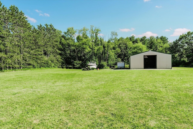 2098 Fisher Ct, Howell, MI 48855 - view of green lawn with an outdoor structure, a pole building, and a garage