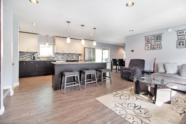 5885 Rockcroft Blvd, Clarkston, MI 48346 - living area featuring healthy amount of natural light, recessed lighting, and light wood finished floors