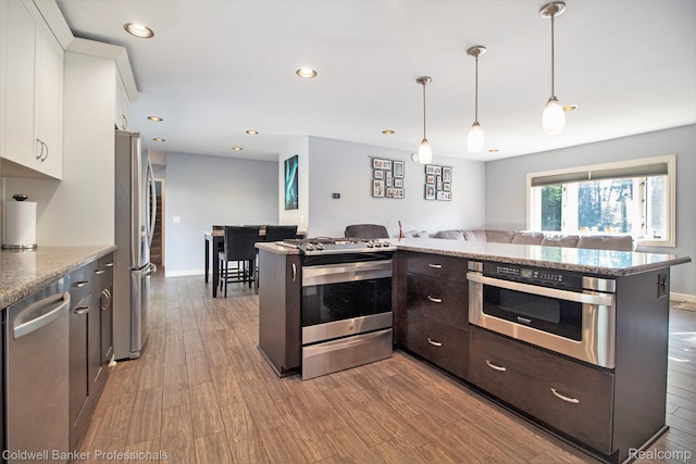 5885 Rockcroft Blvd, Clarkston, MI 48346 - kitchen featuring appliances with stainless steel finishes, open floor plan, white cabinetry, dark brown cabinets, and wood finished floors