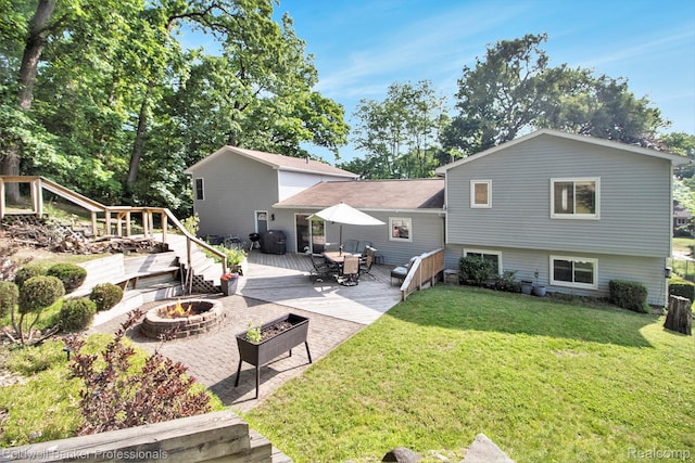 5885 Rockcroft Blvd, Clarkston, MI 48346 - rear view of property with an outdoor fire pit, a deck, and a lawn