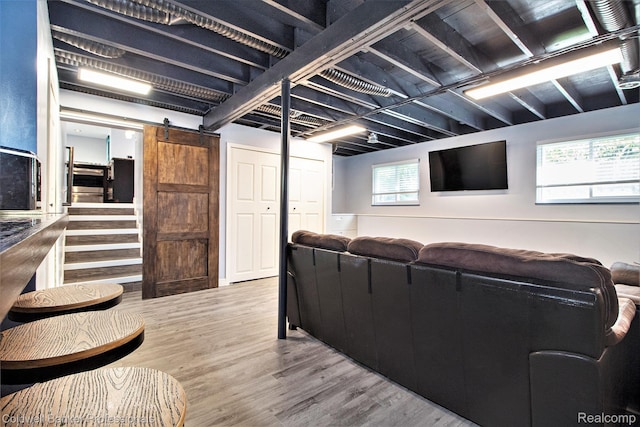 5885 Rockcroft Blvd, Clarkston, MI 48346 - living room featuring a barn door and wood finished floors