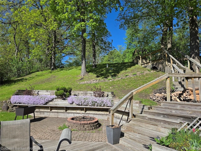 5885 Rockcroft Blvd, Clarkston, MI 48346 - wooden deck featuring a fire pit, stairway, a yard, and a patio