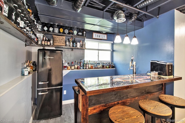 5885 Rockcroft Blvd, Clarkston, MI 48346 - indoor dry bar with freestanding refrigerator and wood finished floors