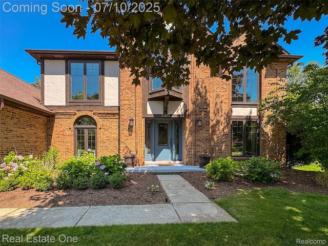 21653 Heatheridge Ln, Northville, MI 48167 - view of front of property with brick siding and a front yard