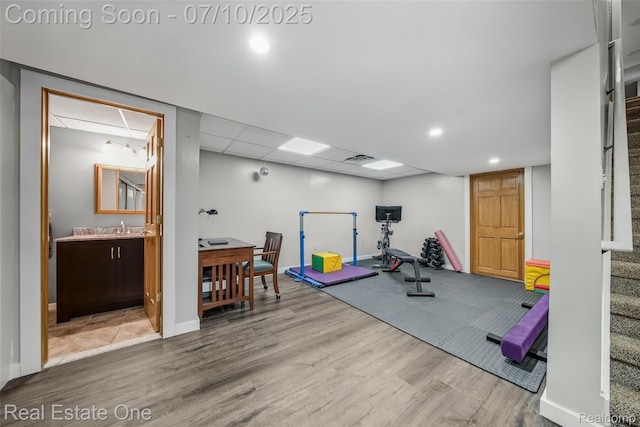 21653 Heatheridge Ln, Northville, MI 48167 - exercise area featuring wood finished floors and a paneled ceiling