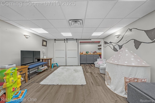 21653 Heatheridge Ln, Northville, MI 48167 - interior space with a drop ceiling, wood finished floors, and a barn door