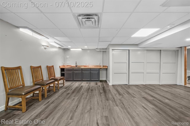 21653 Heatheridge Ln, Northville, MI 48167 - miscellaneous room with wood finished floors, wet bar, and a paneled ceiling