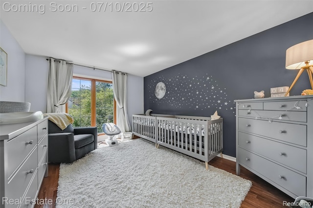21653 Heatheridge Ln, Northville, MI 48167 - bedroom with an accent wall, wood finished floors, a nursery area, and wallpapered walls