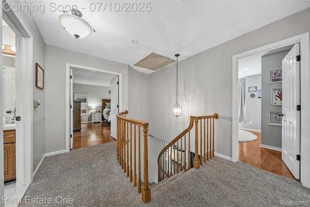 21653 Heatheridge Ln, Northville, MI 48167 - hall featuring an upstairs landing, light colored carpet, and light wood-type flooring