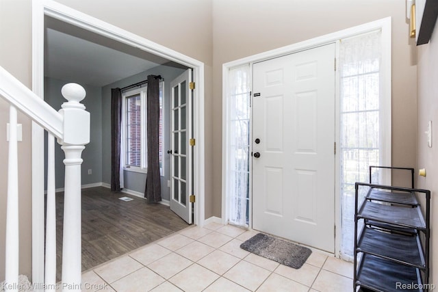 55856 Serene Dr, Macomb, MI 48042 - entrance foyer featuring plenty of natural light, light tile patterned floors, and stairs