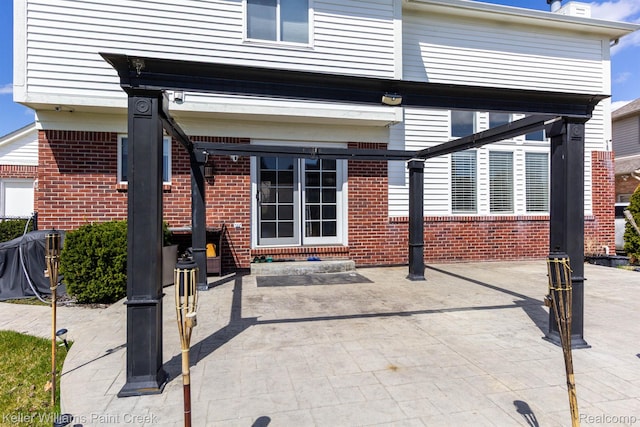 55856 Serene Dr, Macomb, MI 48042 - rear view of property featuring brick siding and a patio