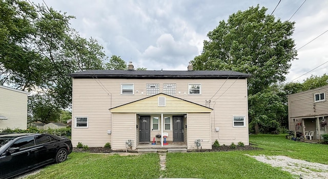 32013 Ottawa St, Westland, MI 48186 - rear view of house with a lawn, covered porch, and a chimney