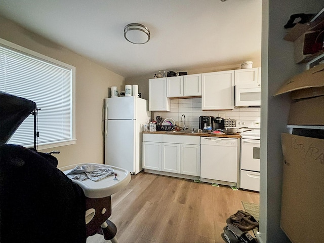 32013 Ottawa St, Westland, MI 48186 - kitchen featuring white appliances, light wood-style flooring, decorative backsplash, and white cabinets