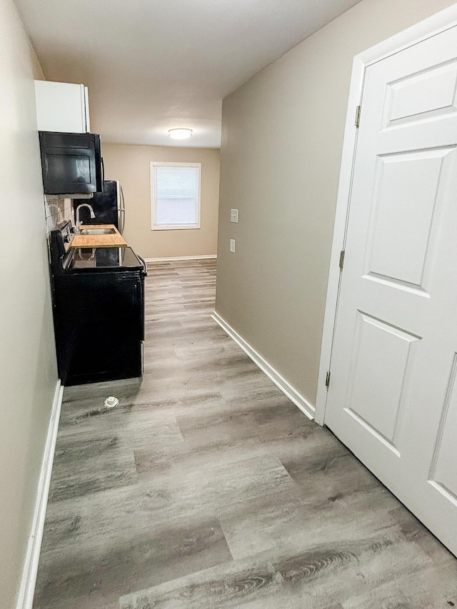 32013 Ottawa St, Westland, MI 48186 - hall featuring light wood-style flooring and baseboards