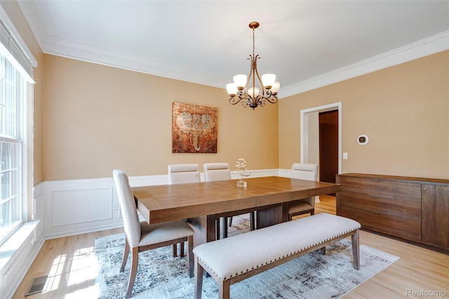 50042 Black Horse Ln, Canton, MI 48188 - dining room featuring light wood-style flooring, ornamental molding, a chandelier, and a wainscoted wall