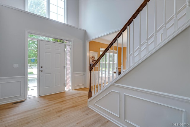 50042 Black Horse Ln, Canton, MI 48188 - entrance foyer featuring a decorative wall, healthy amount of natural light, wainscoting, stairs, and wood finished floors
