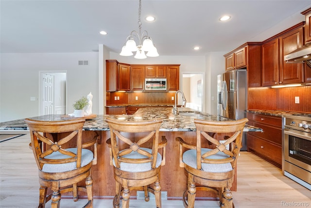 50042 Black Horse Ln, Canton, MI 48188 - kitchen featuring stainless steel appliances, light stone countertops, backsplash, light wood-style floors, and recessed lighting