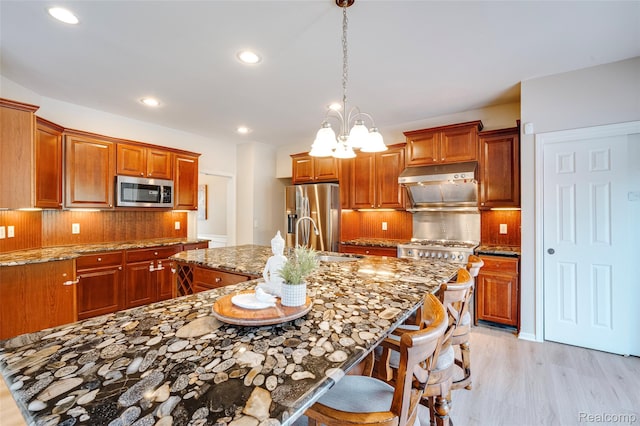 50042 Black Horse Ln, Canton, MI 48188 - kitchen with stainless steel appliances, light wood finished floors, decorative backsplash, light stone counters, and recessed lighting