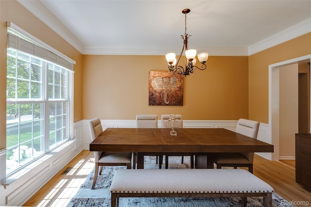 50042 Black Horse Ln, Canton, MI 48188 - dining area featuring healthy amount of natural light, a chandelier, crown molding, light wood finished floors, and a wainscoted wall