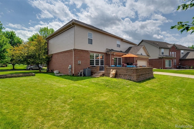 50042 Black Horse Ln, Canton, MI 48188 - back of property with brick siding, a lawn, and a garage