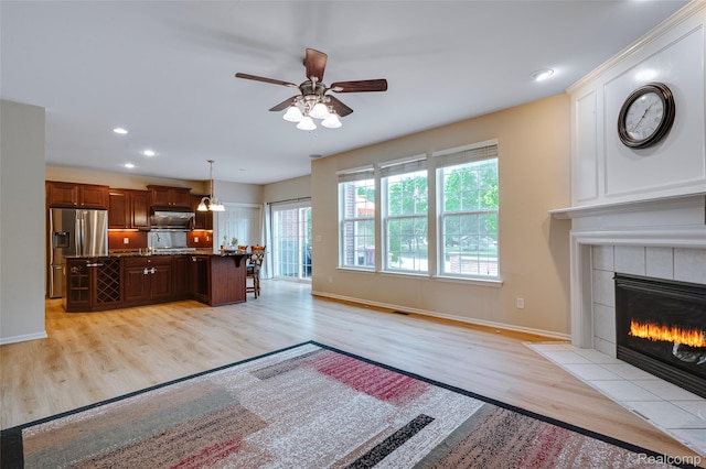 50042 Black Horse Ln, Canton, MI 48188 - living room with light wood finished floors, ceiling fan, a tile fireplace, and recessed lighting
