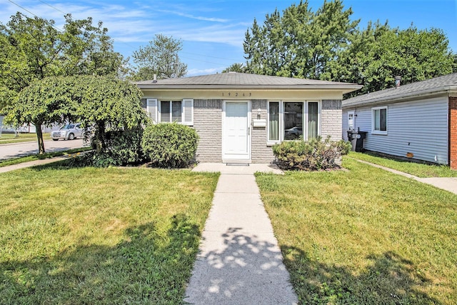 19263 Roger St, Melvindale, MI 48122 - view of front of home with a front lawn and brick siding