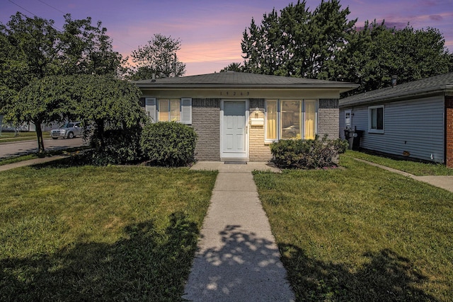19263 Roger St, Melvindale, MI 48122 - view of front facade featuring a front lawn and brick siding