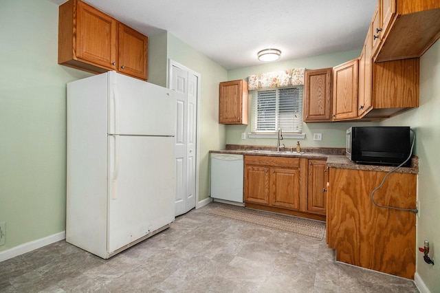 19263 Roger St, Melvindale, MI 48122 - kitchen featuring white appliances, brown cabinets, and dark countertops