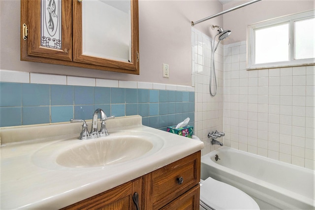 19263 Roger St, Melvindale, MI 48122 - bathroom featuring vanity, shower / bath combination, tile walls, and a wainscoted wall