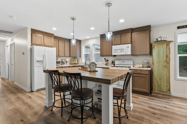 08311 W Shore Dr, Grand Junction, MI 49056 - kitchen with white appliances, wooden counters, wood finished floors, a kitchen bar, and a center island