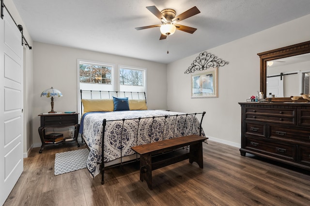 08311 W Shore Dr, Grand Junction, MI 49056 - bedroom with a barn door, wood finished floors, and ceiling fan
