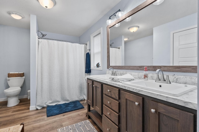 08311 W Shore Dr, Grand Junction, MI 49056 - full bathroom with double vanity, wood finished floors, and a shower with shower curtain
