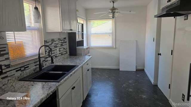 22784 N Kane, Detroit, MI 48223 - kitchen featuring plenty of natural light, decorative backsplash, ceiling fan, and white cabinets