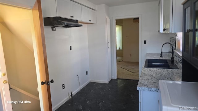 22784 N Kane, Detroit, MI 48223 - kitchen featuring light countertops, white cabinets, and under cabinet range hood