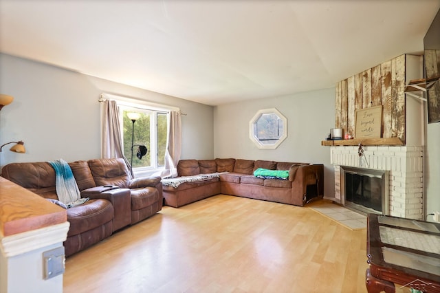 12821 Cimarron Dr, Birch Run, MI 48415 - living area with a brick fireplace and light wood finished floors