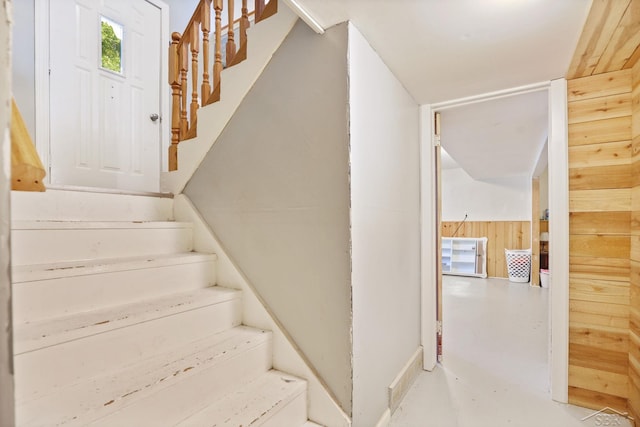12821 Cimarron Dr, Birch Run, MI 48415 - staircase with concrete flooring and wooden walls