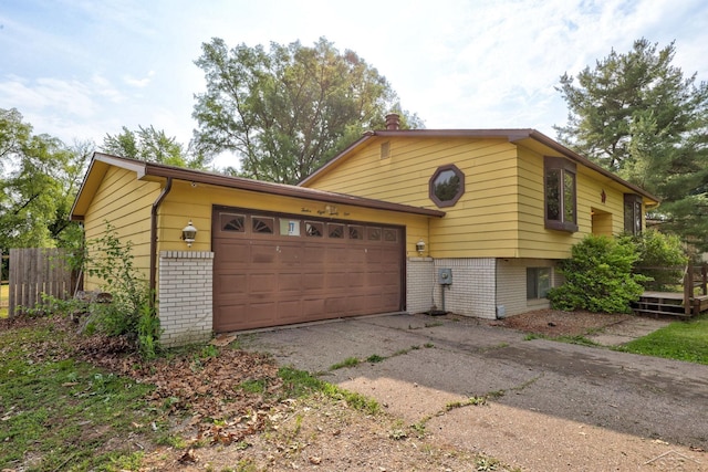 12821 Cimarron Dr, Birch Run, MI 48415 - view of front of home with brick siding, asphalt driveway, and a garage