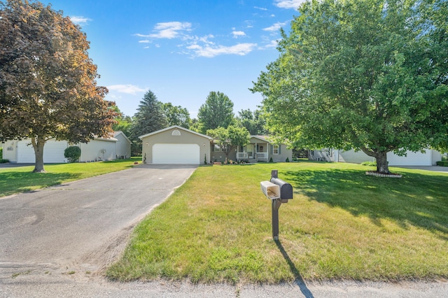 7900 Sunset Shores Dr, Canadian Lakes, MI 49346 - view of front of home featuring an attached garage, driveway, and a front lawn