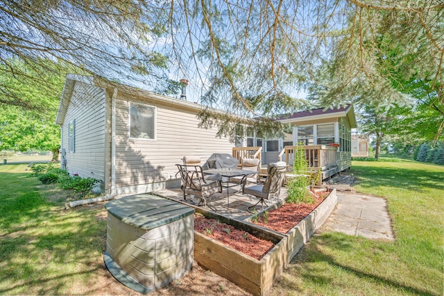 7900 Sunset Shores Dr, Canadian Lakes, MI 49346 - rear view of property featuring a lawn, a wooden deck, and a patio area