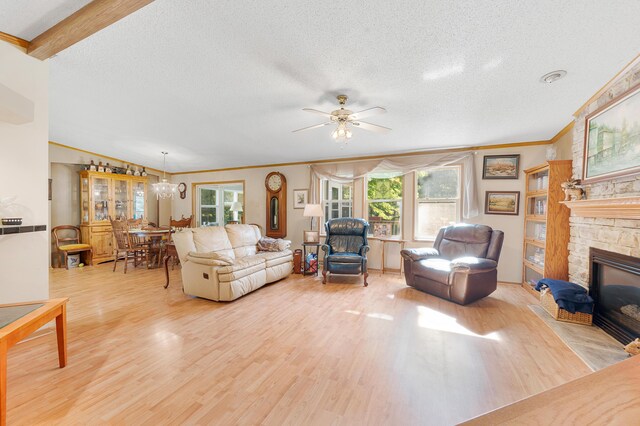 7900 Sunset Shores Dr, Canadian Lakes, MI 49346 - living room featuring wood finished floors, crown molding, a stone fireplace, a chandelier, and a textured ceiling