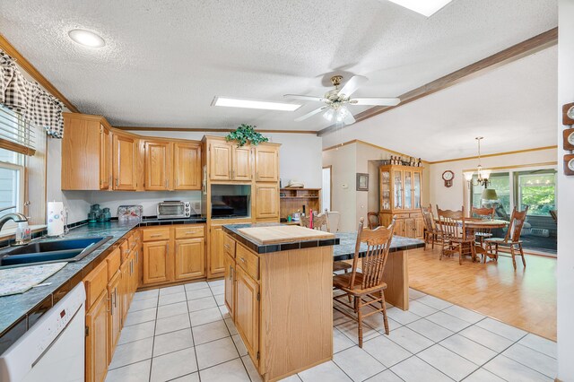 7900 Sunset Shores Dr, Canadian Lakes, MI 49346 - kitchen featuring dishwasher, ornamental molding, tile counters, a kitchen island, and a textured ceiling