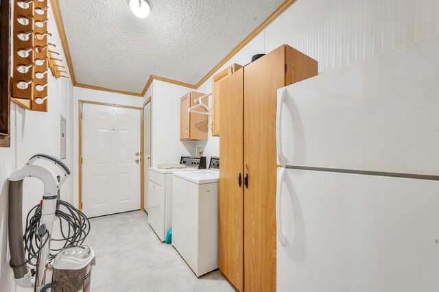 7900 Sunset Shores Dr, Canadian Lakes, MI 49346 - washroom with ornamental molding, a textured ceiling, cabinet space, light floors, and separate washer and dryer