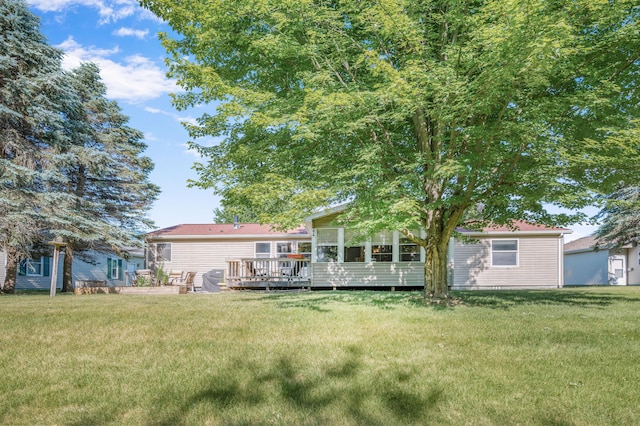 7900 Sunset Shores Dr, Canadian Lakes, MI 49346 - view of grassy yard with a deck