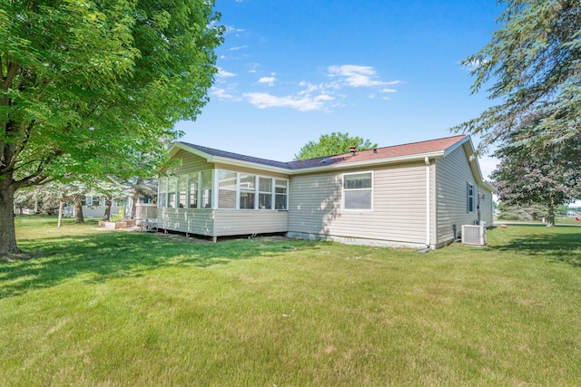 7900 Sunset Shores Dr, Canadian Lakes, MI 49346 - rear view of house with a sunroom and a yard