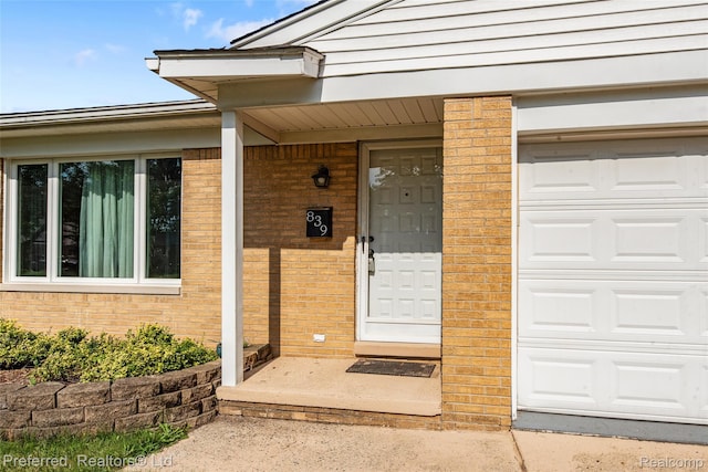 839 Judith St, Westland, MI 48186 - doorway to property featuring brick siding and an attached garage
