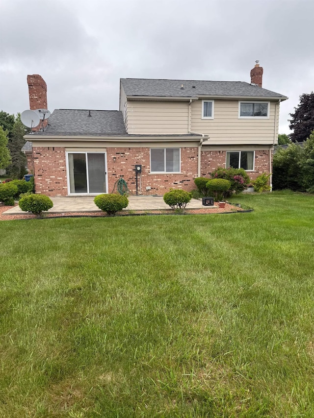 12806 Via Catherina Dr, Grand Blanc, MI 48439 - rear view of house with a patio, brick siding, a chimney, and a lawn
